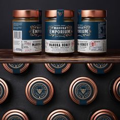 three jars of manuka honey sitting on top of a shelf