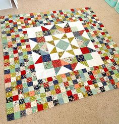 a patchwork quilt is laying on the floor