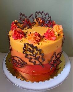 a multi colored cake with flowers on top