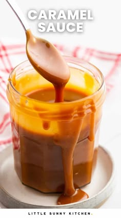 caramel sauce in a small glass jar with a spoon sticking out of the top