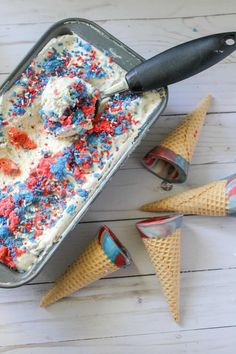 an ice cream with red, white and blue sprinkles in a tin