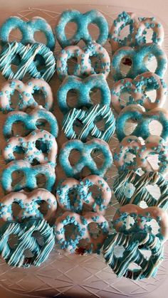 blue and white frosted donuts are arranged on a plate