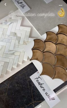 there are many different types of tiles on the counter top, including one that is brown and white