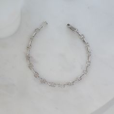 This handmade chain bracelet is dainty and beautiful. It features pave stones that connect each link beautifully! It's great as a gift or for yourself. Great stacked or worn alone! We use a THICK plating of 14k Gold or Rhodium over brass Available in 6.25", 6.75" or 7" Lengths Not adjustable We use the Highest Grade of Cubic Zirconia for an authentic look! Bracelets on Model: Daryl-Ann's Sunburst Bracelet Unsure of your bracelet length? Use our Bracelet Sizer Tool! Diamond Chain Bracelet, Handmade Chain, Chunky Earrings, Diamond Chain, Stacked Jewelry, Dainty Bracelets, Initial Jewelry, Gold Bracelet Chain, Statement Bracelet