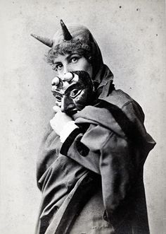 an old photo of a man with horns on his head and wearing a costume that looks like a devil