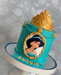 a blue cake with an image of princess pocahone on it's top