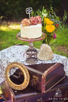 a cake sitting on top of an old suitcase