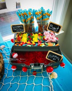 a table topped with candy and candies on top of a blue cloth covered table