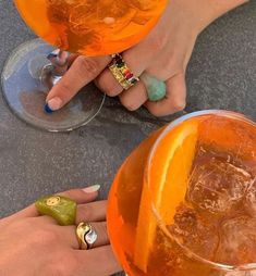 two people are holding oranges in their hands and one has a ring on it