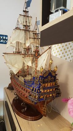 a model ship is sitting on top of a table