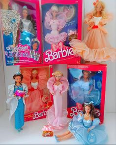 barbie dolls are in their boxes on the table