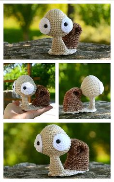 crocheted snail with eyes and tail made to look like it is holding something in its mouth