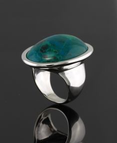 30x22mm oval  chrysocolla cabochon set in sterling silver ring.  Available with any type of gemstone. *Cabochon *Flat *Buff top *Rose cut ( depending on availability)  This ring is high polished and is also available with textured surface. Please indicate your ring size. Also available in gold.  Price in 14kt white or yellow gold $1050.00 Modern Oval Turquoise Gemstone Ring, Elegant Oval Turquoise Ring With Large Stone, Turquoise Oval Cabochon Ring With Polished Finish, Oval Silver Chrysocolla Turquoise Ring, Oval Turquoise Chrysocolla Ring In Silver, Large Stone Rings, Lapis Ring, Sterling Silver Rings Set, Silver Ring Set