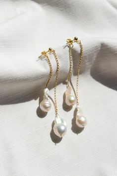 Completely handcrafted in our New York studio, the Waterfall Pearl 360 Earrings are composed of organically shaped freshwater pearls suspended from 14k gold filled or sterling silver chain.  Designed for a 360 view with front and back strands.  Due to the nature of handmade, each pair is slightly different and unique to you."WATERFALL FRESHWATER PEARL 360 EARRINGS" by GoldenLinings - Christine Elizabeth JewelryD E T A I L S_________________Materials: 14K Gold Fill or Sterling SilverClosure: latc Minimalist Akoya Pearl Drop Earrings Jewelry, Minimalist Akoya Pearl Drop Earrings, Minimalist Baroque Pearl Chain Earrings, Pearl Charm Drop Earrings For Wedding, Delicate Baroque Pearl Earrings For Pierced Ears, Delicate Akoya Pearl Earrings In Pearl White, Wedding Pearl Charm Drop Linear Earrings, Delicate Long Drop Pearl Pendant Earrings, Minimalist Pearl Earrings With Pearl Chain For Anniversary