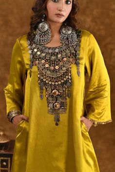 Mustard yellow silk kurta with coin, charms and metallic tassel embellishments on olive green patchwork bodice. Comes with a wrap palazzo. - Aza Fashions Designer Gold Sets With Motifs, Bohemian Gold Sets For Eid, Gold Bohemian Sets With Zari Work, Bohemian Gold Sets With Zari Work, Gold Bohemian Kurta With Zari Work, Olive Green Combination, Wrap Palazzo Pants, Green Dupatta, Women Kurta