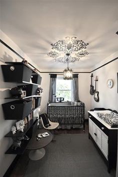 a bedroom with black and white decor in the corner, including a crib bed