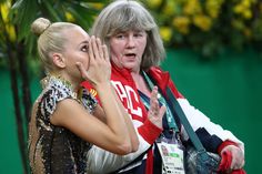 two women standing next to each other with their hands on their faces