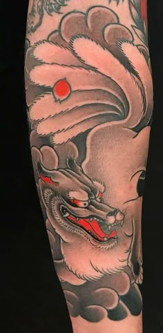 a man with a dragon tattoo on his leg