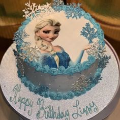 a frozen princess birthday cake with blue frosting