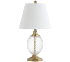 a glass table lamp with a white shade on the top and gold trimmings