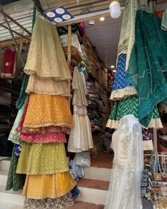 there are many dresses on display in the store