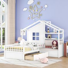 a child's bedroom decorated in white and pink with stars on the wall above the bed