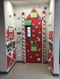 a red door decorated with snowflakes and candy canes