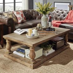 a living room with leather couches and a coffee table in the middle, surrounded by other furniture