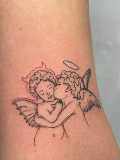 a couple hugging each other with an angel tattoo on their arm and behind them is a red heart