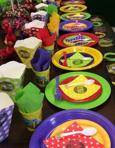 the table is set up with colorful plates and cups for children to enjoy their birthday