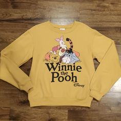 New With Tags This Womens Disney Winnie The Pooh Character Print Sweatshirt Is A Size Extra Small. It Is Golden Brown In Color With A Large Character Print On The Front. There Is Elastic At The Neck, Sleeves, And Waist. Made Of 60% Cotton And 40% Polyester. Measurements Are 25 Inches From Shoulder To Bottom, 19 Inches Armpit To Armpit, And 24 Inch Sleeves. Disney Character Print Tops For Fall, Fall Disney Character Print Tops, Disney Letter Print Top For Fall, Cute Long Sleeve Tops For Disney Fan Events, Pooh And Piglet Quotes, Piglet Quotes, Winnie The Pooh Character, Mustard Yellow Top, Mickey Sweatshirt