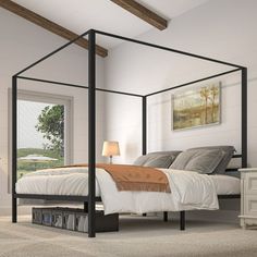 a bedroom with a four post bed, dresser and night stand in the corner on carpeted flooring