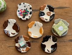 small ceramic animal plates sitting on top of a wooden table