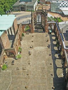 an aerial view of a building with people sitting on the ground and walking around it