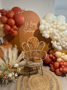 an assortment of balloons and decorations on display in a room with a wicker chair