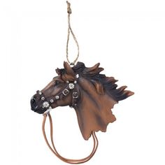 a horse head ornament hanging from a rope