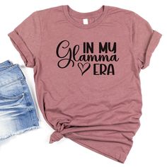 Celebrate your glamorous grandma with a one-of-a-kind Custom "In My Glamma Era" Shirt! This personalized Glamma tshirt is the perfect Mothers Day gift for Glamma or holiday gift for mom. Whether it's for a pregnancy reveal or just to show appreciation, this Custom Glamma Shirt will make her feel extra special. Surprise your beloved Glamma with a unique and heartfelt gift that she can proudly wear to showcase her status in the Glamma era! *Product Details - Printed with ink - Unisex T-Shirt - Ult Glamma Shirt, Pregnancy Reveal, Baby Reveal, Pregnancy Reveals, Heartfelt Gifts, Cricut Ideas, Shirt Ideas, Grandchildren, Small Designs