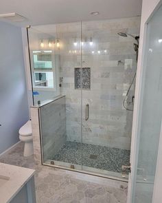 a bathroom with a walk in shower next to a sink