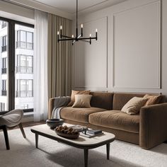 a living room filled with furniture and a chandelier hanging from the ceiling next to a window