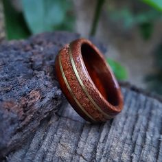 "☉ Cocobolo and Itin exotic south american tropical wood ring with a centered band of crushed Goldstone and Bronze inlays. The Stone has a glimmering like effect with small gold stars, a sparkly one of a kind stone. ☉ * Made to order in all sizes. * Finished with multiple layers of CA achieving a strong high-gloss polish * Extremely durable and water resistant. *Shipping* This item includes free domestic and international shipping. Its delivery process takes from 15 to 20 business days and it do Nature-inspired Red Rings As Gifts, Nature-inspired Red Rings For Gifts, Unique Brown Jewelry With Inlay, Unique Mahogany Jewelry For Gift, Rustic Red Jewelry As A Gift, Rustic Red Jewelry For Gifts, Artisan Brown Inlay Jewelry, Rustic Ring Jewelry Gift, Unique Brown Jewelry For Anniversary