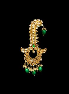 Indian groom's wedding jewelry has the power to make every bridal outfit special. This groom's pagri jewelry is called the Kalgi which is accented with green emeralds and CZ crystal gems at the center. If you wish to accessories your Punjabi Pagri with the perfect statement jewelry then is the one for you. Glamourous emerald gems adorn this Kalgi jewelry. Lux CZ crystals run all over this Kalgi adding glam to this men's head accessory. Precious mini-pearls accent this gold-plated men's bridal Ka Groom Wedding Jewellery, Red Coral Jewellery, Coral Jewelry Set, Pink Jewelry Set, Bridal Choker, Bridal Outfit, Emerald Gem, San Ramon, Indian Jewelry Sets