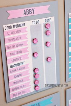 three magnets with pink and blue polka dots on them are attached to the wall