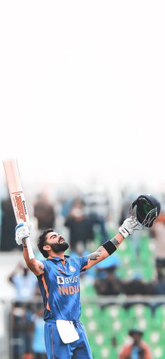 a man holding a cricket bat in his hands