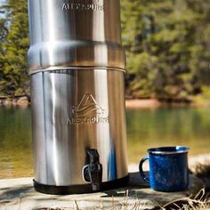 a stainless steel water heater next to a lake