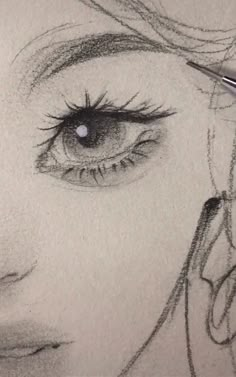 a pencil drawing of a woman's face with long eyelashes and eyeliners