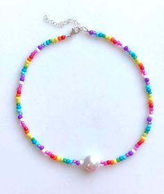 Trendy candy colored beaded choker with Baroque pearl focal. Premium Czech and Japanese seed beads on beaded choker with bright white Baroque freshwater pearl focal. Tiny seed beads in rainbow of candy colors are 3-4 mm glass beads. Beaded choker is 14 inches with 2 inches extension. Sterling silver lobster claw clasp and findings. Fun trendy candy colored jewelry! Pearl Choker With Colorful Round Beads, White Pearl Choker With Colorful Beads, White Pearl Choker Necklace With Colorful Beads, White Beaded Choker Necklace With Pearl Charm, White Beaded Choker With Pearl Charm, White Pearl Choker Necklace For Summer, White Pearl Choker For Summer, White Beaded Pearl Necklace For Festivals, Raw Citrine Necklace