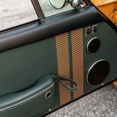 the interior of an old fashioned car with its door open and side view mirror on it