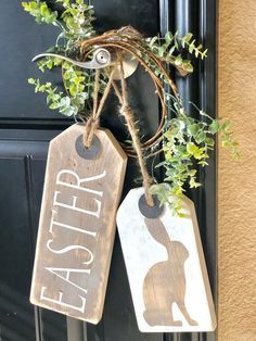 two wooden tags hanging from a door with plants in them and the words easter written on them