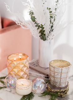 two candles are sitting on a marble table