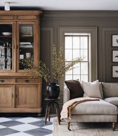 a living room with a checkered floor and wooden furniture in the centerpieces